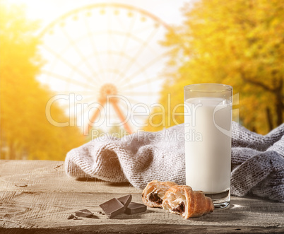 Milk with a croissant on a wooden table