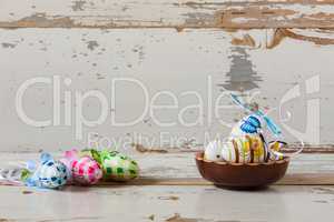 Painted handmade easter eggs inside a wood bowl