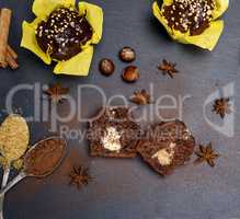 chocolate cake in yellow paper on a black background