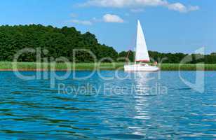 a lone yacht on the horizon, the yacht with masts lonely swims