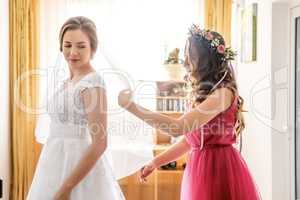 Bridesmaid and bride in white dress