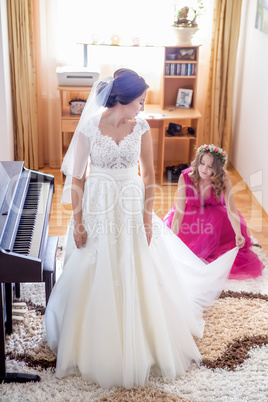 Beautiful young bride in wedding dress and bridesmaid