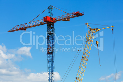 Two construction cranes