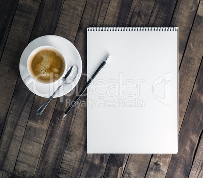 Notebook, coffee cup, pencil