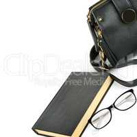 Bag, glasses and book isolated on white background. Free space f