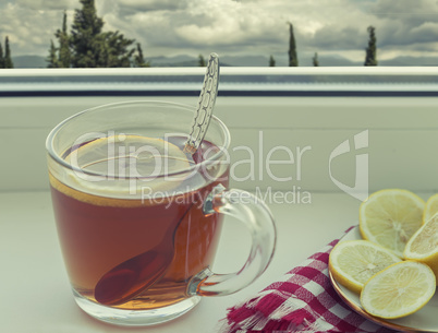 A Cup of tea and a lemon on the window sill