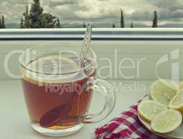 A Cup of tea and a lemon on the window sill