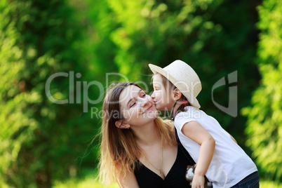 Child kisses his mother