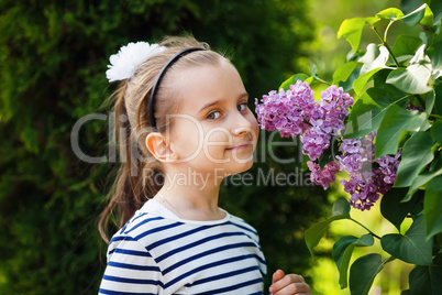 Girl smelling lilacs