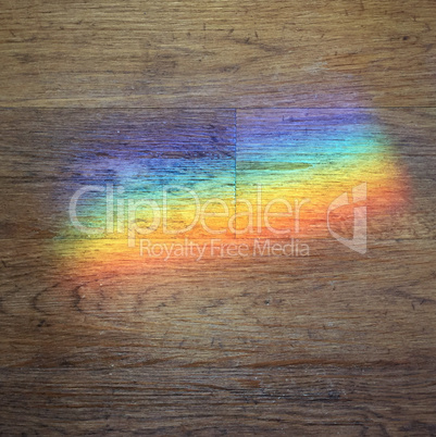 color prism projected onto a wooden floor
