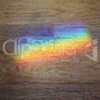 color prism projected onto a wooden floor