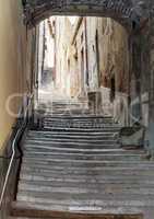 ancient staircase with an arch in the center of Cortona