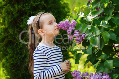 Child smelling lilacs