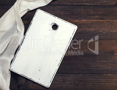 empty white wooden cutting board and a white kitchen towel