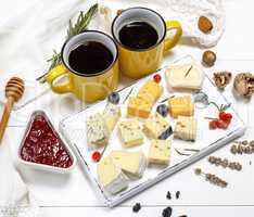 pieces of cheese on a white wooden board