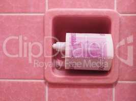 Pink tiles background with toilet paper