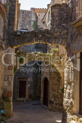 Beautiful old stone arcs in Spanish ancient village, Pals, in Costa Brava