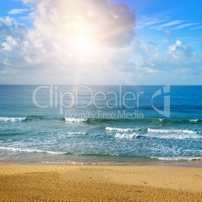 Beautiful seascape and sun on blue sky background. Extensive san