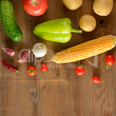 A set of vegetables laid out on a wooden table. Top view. Free s