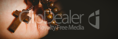 Hand holding rosary beads