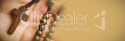 Hand holding rosary beads