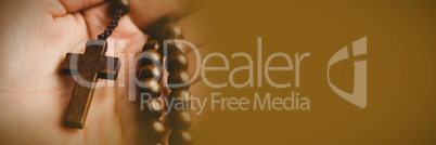 Hand holding rosary beads