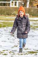 Child Runs Over Snowy Meadow