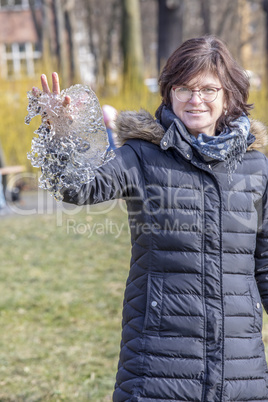 Woman holds ice piece in hand