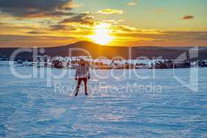 Woman in snow landscape with sunset