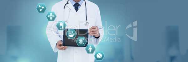 Doctor holding tablet with medical interface hexagon icons