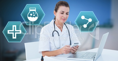 Female doctor using phone with medical interface hexagon icons