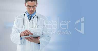 Male doctor holding tablet