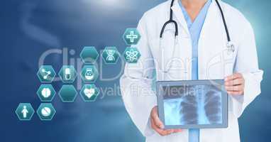 Doctor holding tablet with medical interface hexagon icons and X-Ray