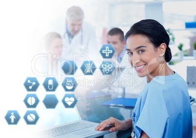 Female doctor holding tablet with medical interface hexagon icons