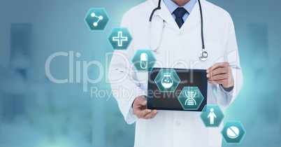 Doctor holding tablet with medical interface hexagon icons