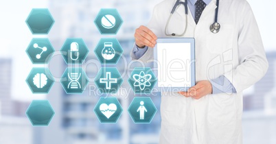 Doctor holding tablet with medical interface hexagon icons