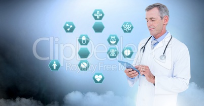 Male doctor holding tablet with medical interface hexagon icons