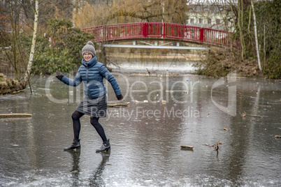 Woman on frozen pond in winter
