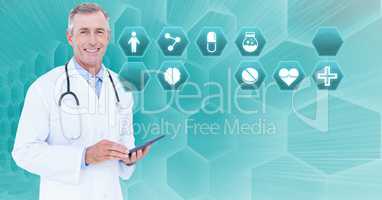 Male doctor holding tablet with medical interface hexagon icons