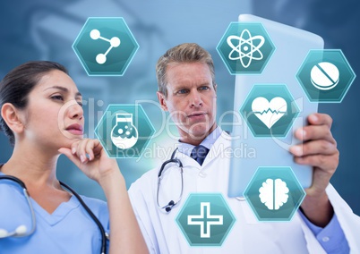 Doctor's holding tablet with medical interface hexagon icons