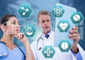 Doctor's holding tablet with medical interface hexagon icons