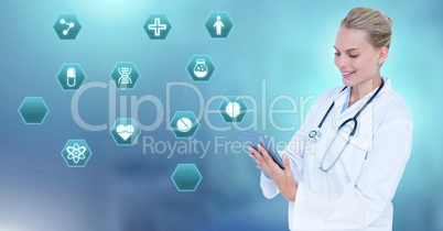 Female doctor holding tablet with medical interface hexagon icons