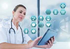 Female doctor holding tablet with medical interface hexagon icons