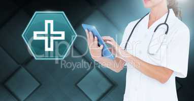 Female doctor holding tablet with medical cross interface hexagon icon