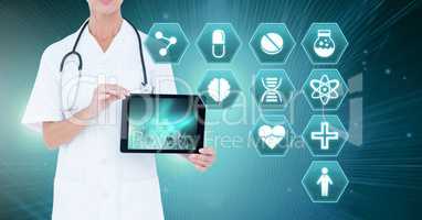 Female doctor holding tablet with medical interface hexagon icons
