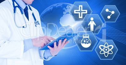 Male doctor holding tablet with medical interface hexagon icons and world