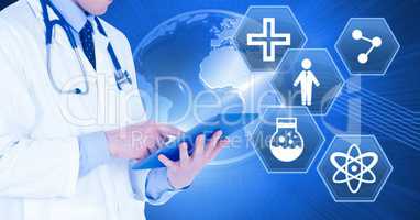 Male doctor holding tablet with medical interface hexagon icons and world