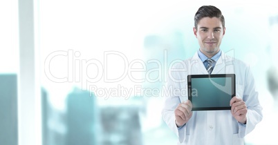 Male doctor holding tablet