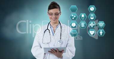 Female doctor holding tablet with medical interface hexagon icons