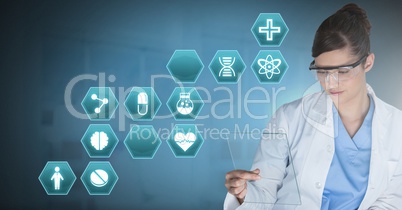 Male doctor holding tablet with medical interface hexagon icons